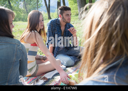 Friends sitting having picnic Banque D'Images