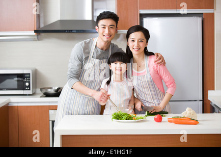 Young family cooking in kitchen Banque D'Images