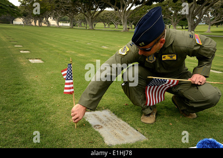 Andy Stewart, 15e Groupe d'action du commandant de l'Escadre, place un drapeau américain à la main et lei au dessus d'une fosse, D Banque D'Images