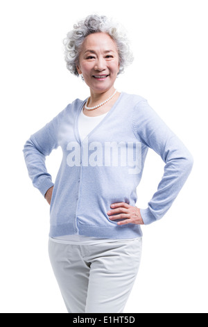 Happy senior woman with hands on hip Banque D'Images