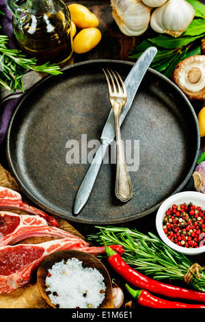 Matières des côtelettes d'agneau avec des légumes, herbes et épices Banque D'Images