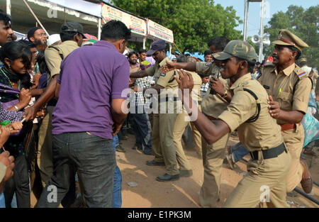 Hyderabad. 8 juin, 2014. Les policiers tentent de contrôler les asthmatiques se précipitant pour recevoir une "médecine" de poissons qui, espèrent-ils, les guérir à Hyderabad, Inde le 8 juin 2014. A commencé par l'Bathini Goud famille, la thérapie est une formule secrète d'herbes, transmise par des générations qu'aux membres de la famille. Les herbes sont insérés dans la bouche d'une sardine, ou murrel poisson, et se glissa dans la gorge du patient. Credit : Stringer/Xinhua/Alamy Live News Banque D'Images