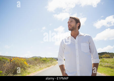 Handsome casual man standing on a road Banque D'Images