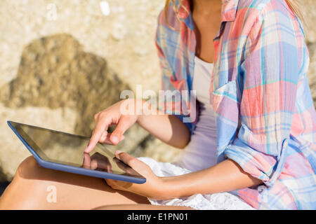 Woman using tablet pc at the beach Banque D'Images