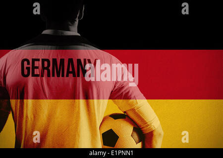 Image composite de l'Allemagne football player holding ball Banque D'Images