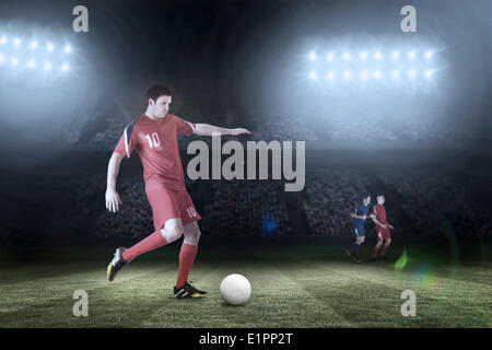 Image composite du joueur de football en rouge des coups Banque D'Images