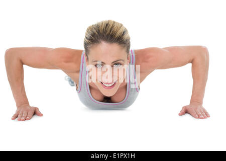 Forte femme faire appuyez sur up smiling at camera Banque D'Images