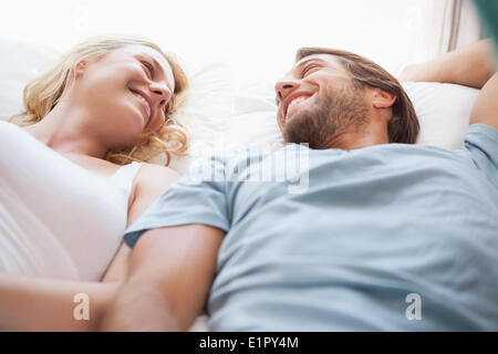 Cute couple lying on a bed Banque D'Images