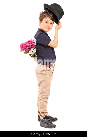 Photo de profil d'un mignon petit garçon holding Flowers derrière son dos Banque D'Images