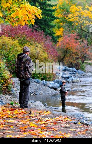 Les jeunes hommes la pêche à la mouche dans la rivière Little Qualicum près de Qualicum, BC, Canada. Banque D'Images