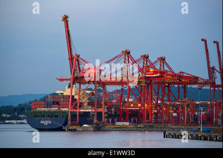 Les conteneurs d'expédition chargement grues sur un cargo au port de Vancover, British Columbia, Canada Banque D'Images