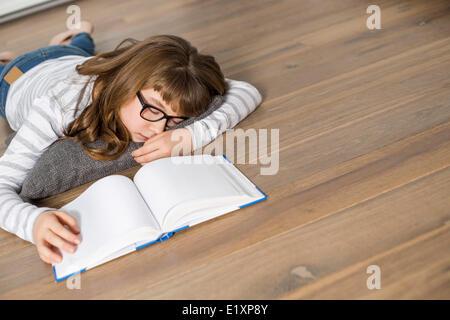 High angle view of teenage girl sleeping while studying on floor Banque D'Images