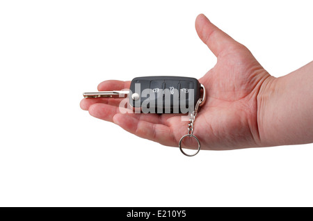 Hand holding car keys over white Banque D'Images