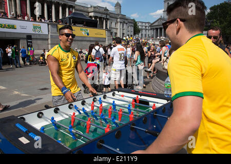 Londres, Royaume-Uni. Jeudi 12 juin 2014. Jouer au baby-foot. Les Brésiliens se réunissent pour les célébrations du Jour du Brésil à Trafalgar Square. Un Rassemblement pour célébrer le début de la Coupe du Monde de la FIFA, Brésil 2014. Revelers chanter et danser et jouer jeux de football et tous les dans le jaune vert et bleu du drapeau brésilien. Crédit : Michael Kemp/Alamy Live News Banque D'Images