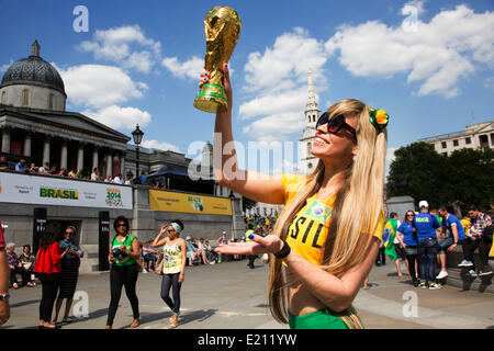 Londres, Royaume-Uni. Jeudi 12 juin 2014. Femme posant avec un trophée de la Coupe du monde. Les Brésiliens se réunissent pour les célébrations du Jour du Brésil à Trafalgar Square. Un Rassemblement pour célébrer le début de la Coupe du Monde de la FIFA, Brésil 2014. Revelers chanter et danser et jouer jeux de football et tous les dans le jaune vert et bleu du drapeau brésilien. Crédit : Michael Kemp/Alamy Live News Banque D'Images