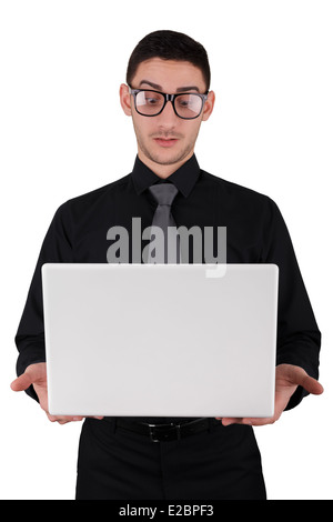 Surpris jeune homme avec des lunettes Holding Laptop Banque D'Images