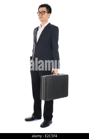 Asian businessman with a suitcase isolated on white Banque D'Images