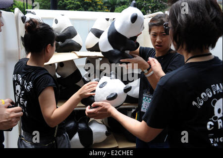 Hong Kong, Chine, Hong Kong. 19 Juin, 2014. Les membres du personnel de s'acquitter de pandas en papier d'une exposition au Victoria Park, Chine du Sud, Hong Kong, le 19 juin 2014. Un total de 1 600 pandas en papier ont été affichées ici le 19 juin, qui étaient l'œuvre de l'artiste française Paulo Grangeon. Credit : Lo Fai Ping/Xinhua/Alamy Live News Banque D'Images