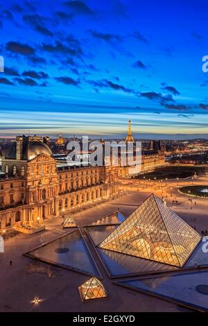 France Paris La pyramide du Louvre par l'architecte Ieoh Ming Pei la nuit Tour Eiffel (⌐ SETE illuminations Pierre Bideau) et dôme des Invalides en arrière-plan Banque D'Images