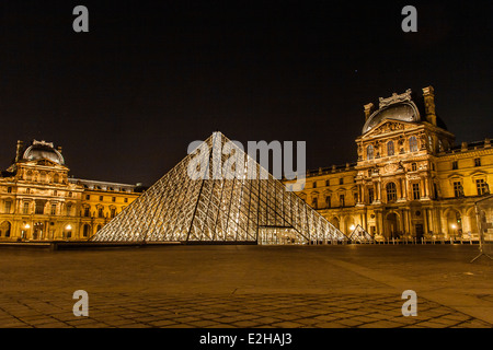 La pyramide du Louvre, d'un grand verre et métal structure pyramidale dans le centre de la galerie d'art du Louvre, Paris. Éclairé la nuit. Banque D'Images