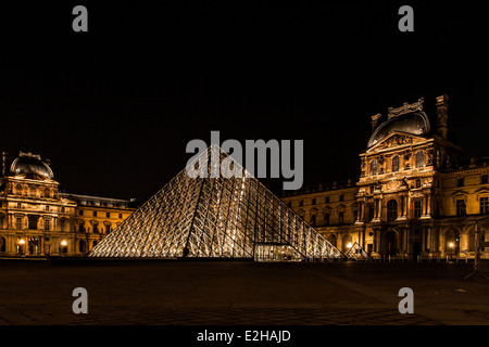 La pyramide du Louvre, d'un grand verre et métal structure pyramidale dans le centre de la galerie d'art du Louvre, Paris. Éclairé la nuit. Banque D'Images