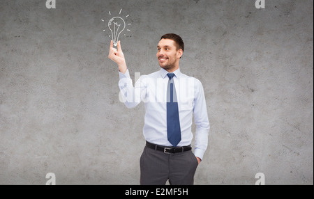 Handsome businessman holding Light bulb Banque D'Images