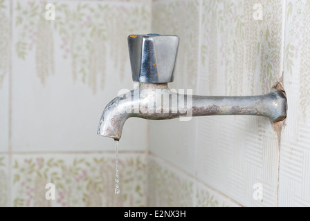 Robinet d'eau rouillée avec goutte d'eau. Banque D'Images