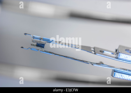 Macro photo de la tête de lecture-écriture du disque dur et le bras reposant sur disque. Métaphore visuelle pour le concept de sécurité des données, le stockage des fichiers. Résumé des données. Banque D'Images