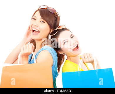 Heureux les jeunes femmes with shopping bags Banque D'Images