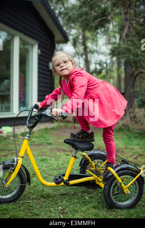 Portrait de fille avec le syndrome de Down en équilibre sur location in lawn Banque D'Images