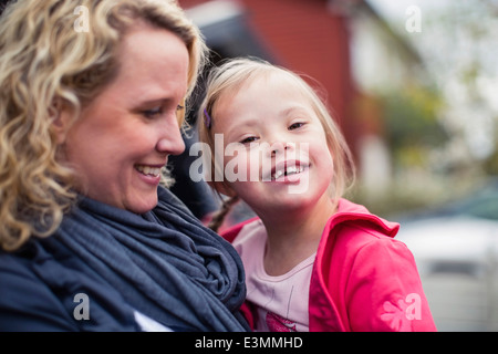 Portrait of happy girl with down syndrome porté par mère Banque D'Images