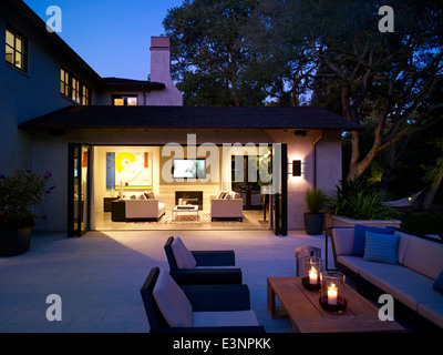 En vue salon éclairé à partir de la terrasse extérieur de maison en pierre, Atherton, en Californie, aux États-Unis. Banque D'Images