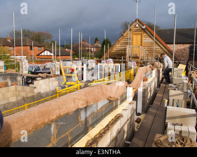 L bâtiment maison, maçon travaillant sur échafaudages levage premier Banque D'Images