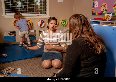 Un Young conseille une mère que son fils joue à un apprentissage en classe 'lien' à Tustin, CA, la conduite d'un atelier interactif dans le comportement. À l'aide d'activités spécialement conçues, la classe enseigne aux parents comment faire participer leurs enfants à jouer utile. Banque D'Images