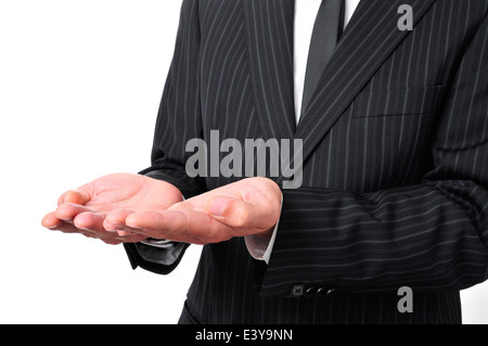 Un homme portant un costume avec ses mains ouvertes, comme la mendicité ou montrant ou quelque chose Banque D'Images