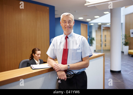 Doctor standing in hospital waiting room Banque D'Images