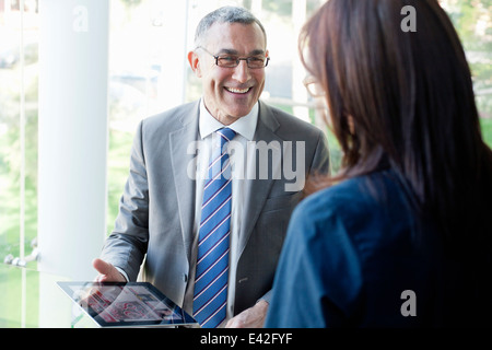 Businessman and woman using digital tablet
