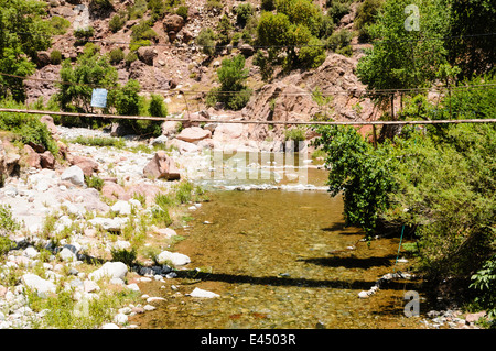 Un pont branlant potentiellement dangereux sur la rivière de l'Ourika, la vallée de l'Ourika, Atlas, Maroc Banque D'Images