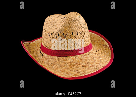 Chapeau de paille cowboy américain traditionnel isolé sur fond noir. Accessoire d'agriculteurs. Banque D'Images