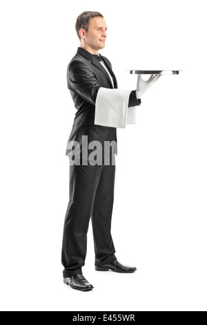 Full Length portrait of a waiter holding a tray et servir Banque D'Images