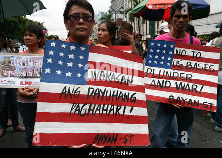 Manille, Philippines. 4 juillet, 2014. Les manifestants tenant des pancartes contre les États-Unis au cours de leur marche vers l'ambassade américaine à Manille. Des groupes militants ont défilé le long de Kalaw Avenue à Manille dans l'air leur opposition contre l'Accord de coopération de défense renforcée entre l'armée américaine et le gouvernement des Philippines. Crédit : J Gerard Seguia/Pacific Press/Alamy Live News Banque D'Images