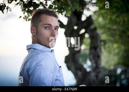 Photo de profil beau jeune homme extérieur looking at camera Banque D'Images