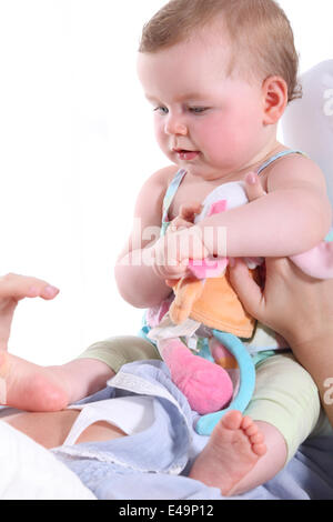 Baby sitting sur la poitrine de sa mère Banque D'Images