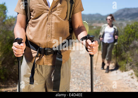 Randonnées en train de marcher sur le sentier de montagne avec des poteaux Banque D'Images