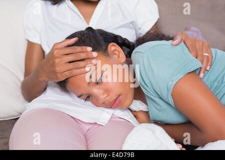 Fille malade allongé sur les mères lap Banque D'Images