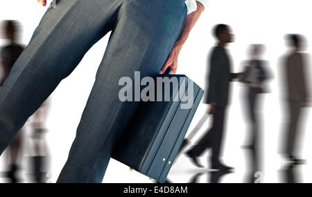 Composite image of businessman holding briefcase Banque D'Images
