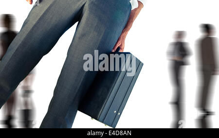 Composite image of businessman holding briefcase Banque D'Images