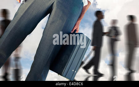 Composite image of businessman holding briefcase Banque D'Images