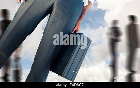 Composite image of businessman holding briefcase Banque D'Images