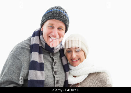 Mature couple in winter clothes smiling at camera Banque D'Images